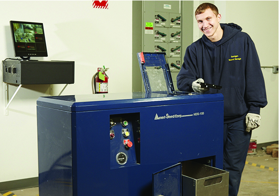 employee performing hard drive destruction